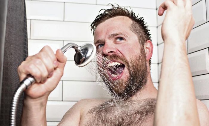 1702205066_1928785_stockphotocutebeardedmansinginginthebathroomusingtheshowerheadwithflowingwaterinsteadofa1149584657_ff.jpg
