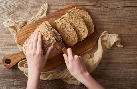 1793198392_top-view-woman-cutting-bread-Depositphotos_271250834_S-1-.jpg